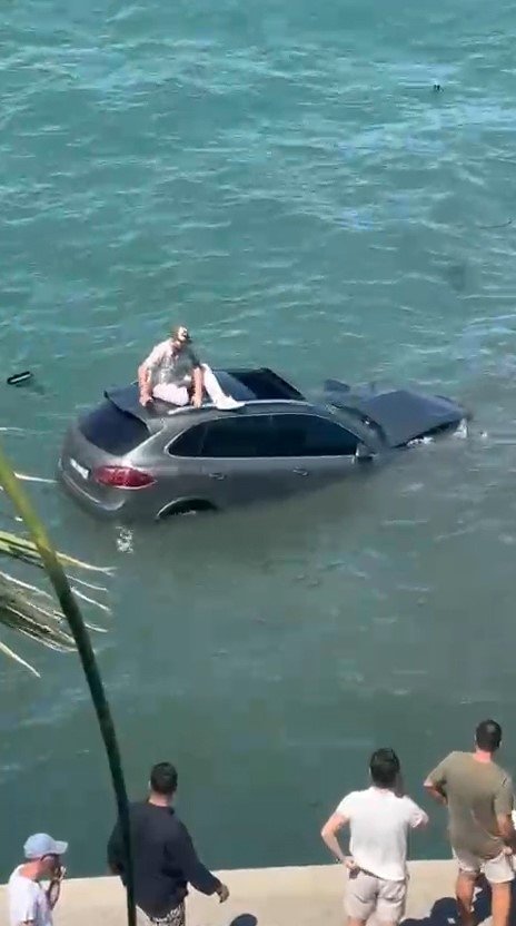 Ayvalık’ta otomobil denize uçtu: Aracın üstüne çıkan sürücü dakikalarca kurtarılmayı bekledi!